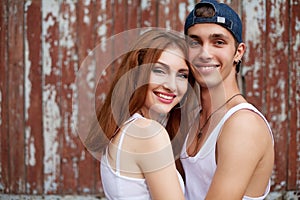 Emotive portrait of a stylish smiling couple standing together n