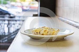 An empanada on a plate, Argentina.