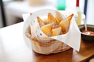 empanadas in a basket with parchment paper