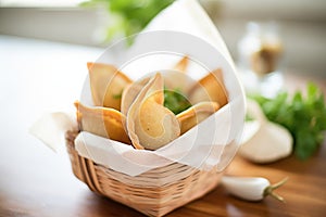 empanadas in a basket with parchment paper