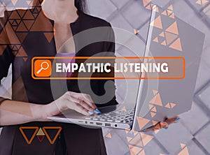 EMPATHIC LISTENING phrase on the screen. Bookkeeping clerk use internet technologies at office. Concept search and EMPATHIC