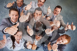 Emphatic approval. Top view of a successful business team giving you an emphatic thumbs up. photo