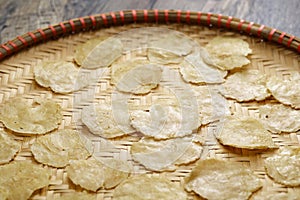 Emping, Indonesian crackers made from crushed Belinjo nuts. Drying on a bamboo tray.