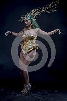 Empire, Latin woman with green hair and gold costume with handmade flourishes, fantasy image and tale