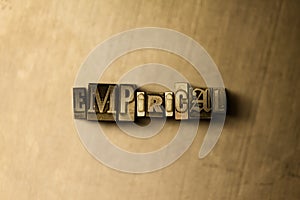 EMPIRICAL - close-up of grungy vintage typeset word on metal backdrop photo