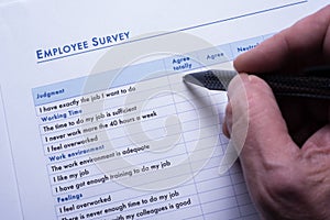 Employee is answering employee survey questions on paper