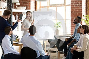 Employee asking questions to female business coach, speaker photo