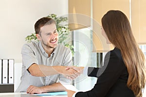 Employee and boss handshaking after a job interview