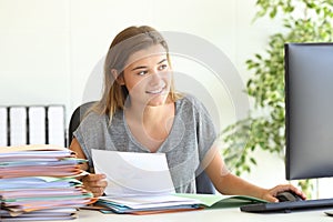 Employee comparing report online at office photo