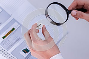 Employee of the Department of technical control checks solderability transitions in the Board photo