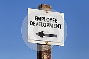 Employee development, word and arrow signpost