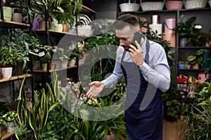 an employee of a florist's shop takes an order by phone