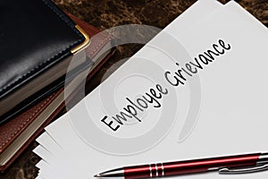 Employee Grievance write on a paperwork isolated on office desk