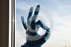 Employee hand in rubber glove with micro fiber cloth cleaning