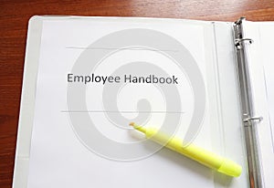 Employee Handbook on a desk photo