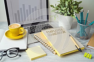 Employee handbook on office table with computer laptop. Business concept for design photo