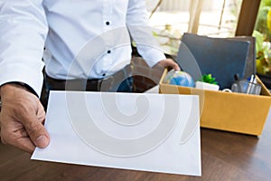 Employee holding resignation letter and Packing a Box To Leave The Office