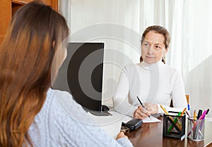 Employee interviewing young woman