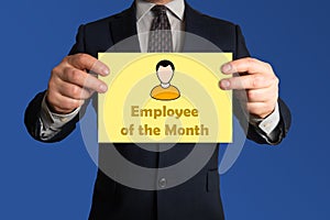 Employee of the month award. Businessman with a sheet of paper stating employee of the month.