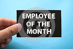 Employee of the month, text words typography written on paper against blue background, life and business motivational