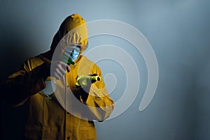 An employee in a protective suit disinfects the room