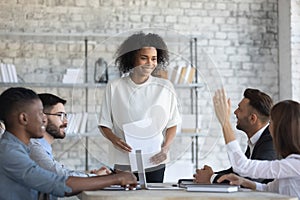 Employee raising hand, asking question to African American business coach