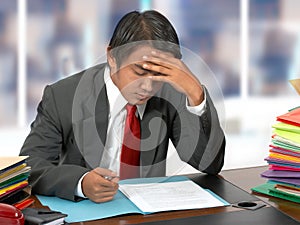 Employee Reading Documents At His Desk