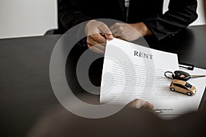 An employee of the rental car company submits a car rental agreement.