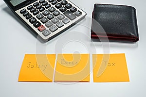 Employee salary management after bonus and tax deduction with calculator and wallet