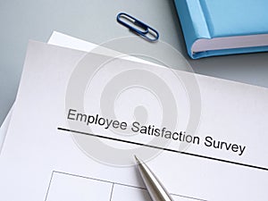 Employee satisfaction survey and pen on the table.