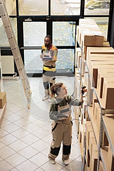 Employee scanning cardboard boxes using store scanner