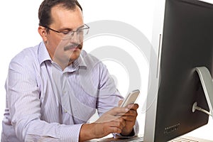 Employee sitting behind desk and dials number on photo