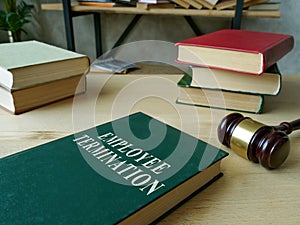 Employee termination rules book and wooden gavel.