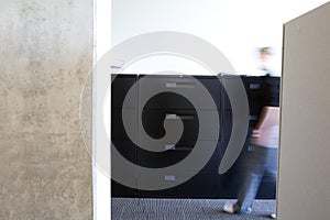 Employee walking in clean modern office.