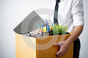 The employee was fired from carrying a brown cardboard box with his equipment. Concept of the unemployed and the economy