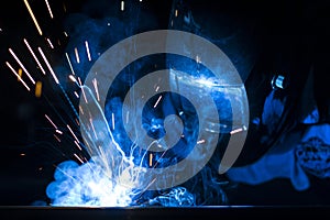 Employee welding using MIG/MAG welder photo
