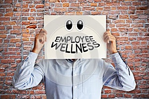 Employee wellness or benefits concept with man holding a paper board above head