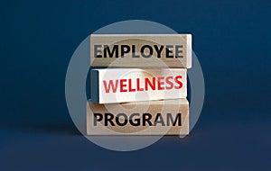 Employee wellness program symbol. Concept words `Employee wellness program` on wooden blocks. Beautiful grey background. Copy