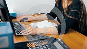 Employee working on computer in office. Scrolling through a spreadsheets