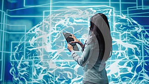 Employee working on tablet, developing AI machine learning algorithms