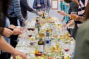 Employees of the company at the Banquet. Table with delicacies, alcohol and snacks. A gala reception