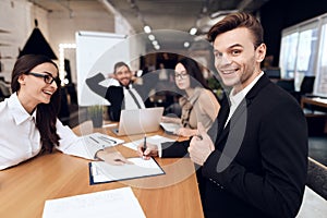 Employees of the company hold a meeting at the table.