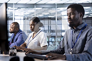 Employees in data center deploying and error checking utilities on computer