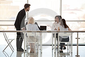 Employees discuss new project with boss holding business briefing photo