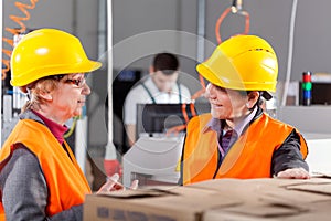 Employees discussing at production area