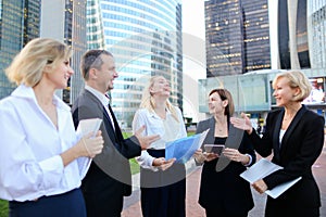 Employees of large corporation going with document case, laptop