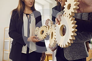 Employees learn to cooperate and find solutions with the help of gears in team building training.