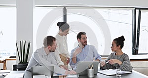 Employees listen speech of team leader during meeting in office