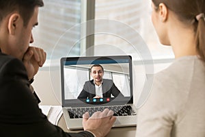 Businesspeople holding online meeting on laptop, making video ca