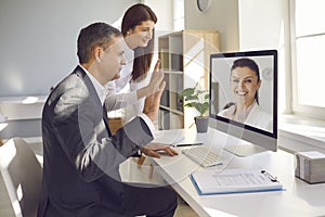 Employees participate in a virtual conference with a boss who conducts business remotely.